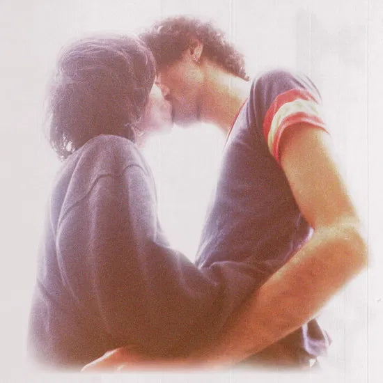 Two people embracing with a soft, warm glow