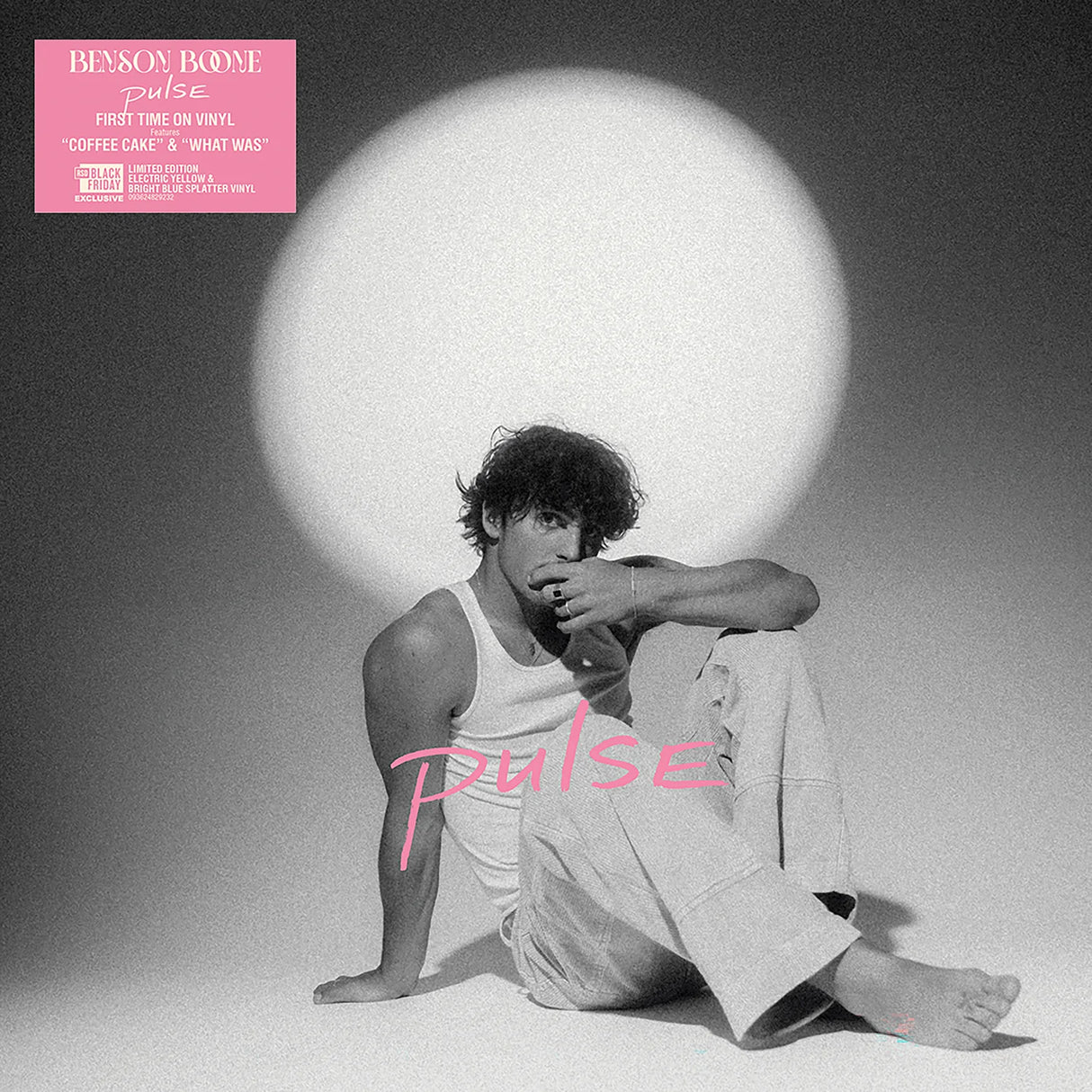 Album cover with a person sitting in front of a large white circle, featuring the word 'Pulse' and a pink label.