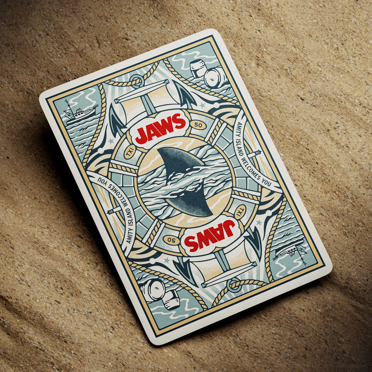 Playing card with 'Jaws' design featuring a shark and text on a textured surface