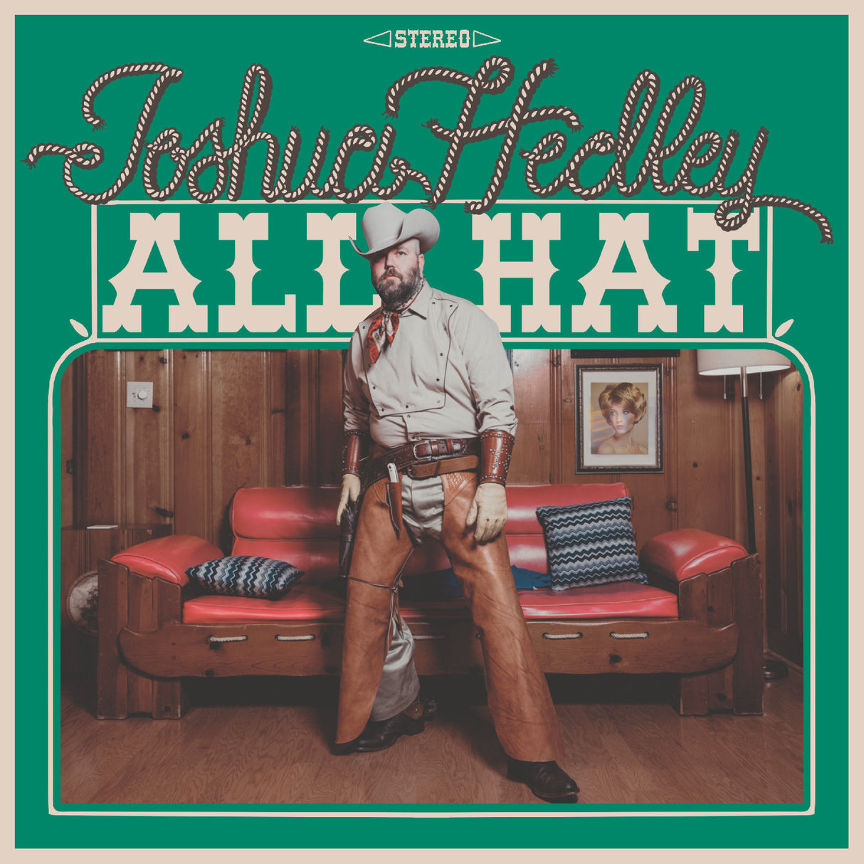 Album cover with a person in cowboy attire in a room with red couches and wooden walls.