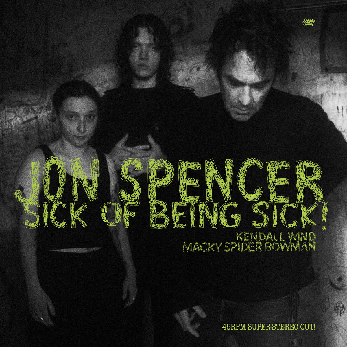 Album cover with text 'Jon Spencer Sick of Being Sick!' featuring three people in a dark setting.