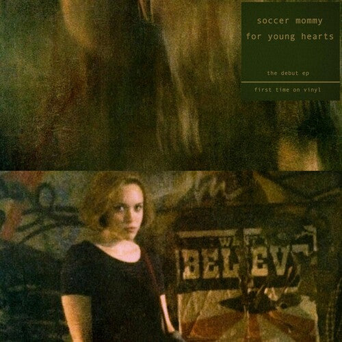 Person standing in front of a record player with album cover text overlay