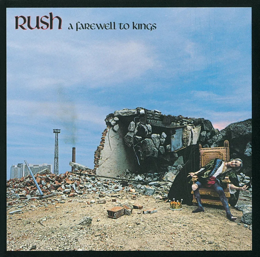 Album cover for Rush's 'A Farewell to Kings', featuring a man in historical clothing sitting on a throne in a ruined cityscape under a blue sky.