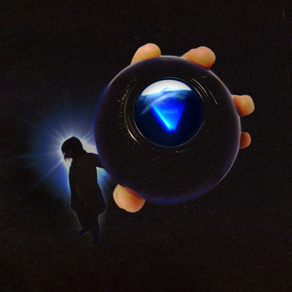 A hand holding a black spherical object with a glowing blue triangular symbol in the center, set against a dark background with a faint silhouette and light effect.