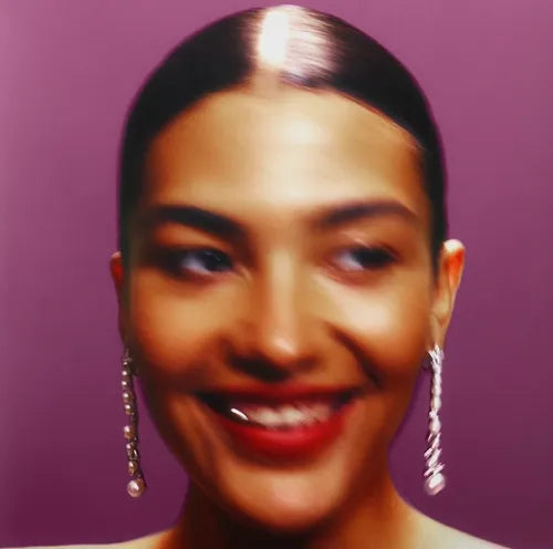 Close-up of a person with a purple background