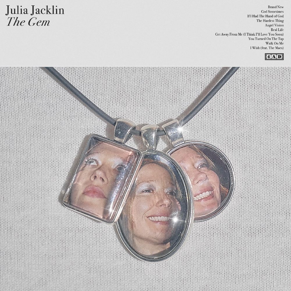 Album cover with pendant featuring three faces and text 'Julia Jacklin The Gem'.