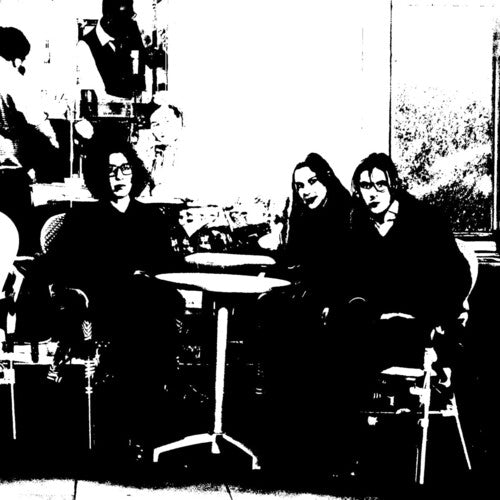 Black and white photograph of a trio sitting at a table, presumably the band 'Bar Italia' for their album 'Tracey Denim LP'.
