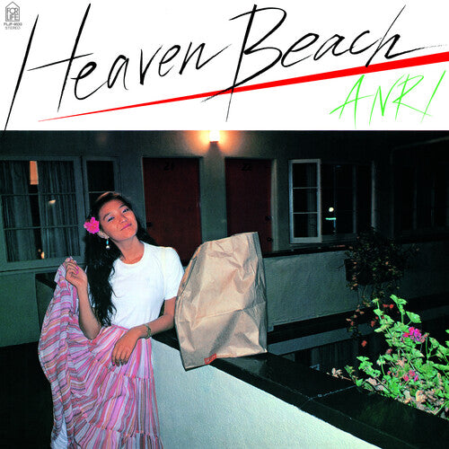 A vinyl record titled 'Heaven Beach' by Anri with a visual representation of a woman standing on a balcony at night, holding a flower, with the album title and artist name in stylized text.