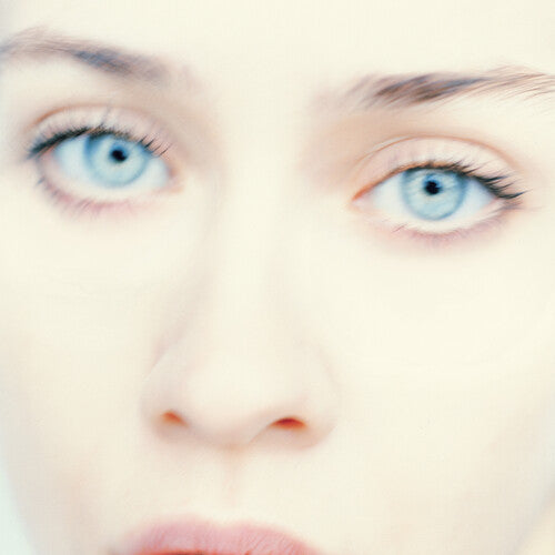 Close-up of a person's eyes looking slightly to the side, with a soft-focused background.
