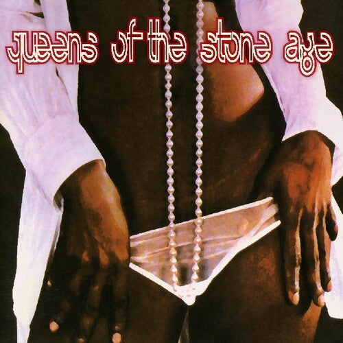 Album cover with 'queens of the stone age' text and a person holding a necklace.