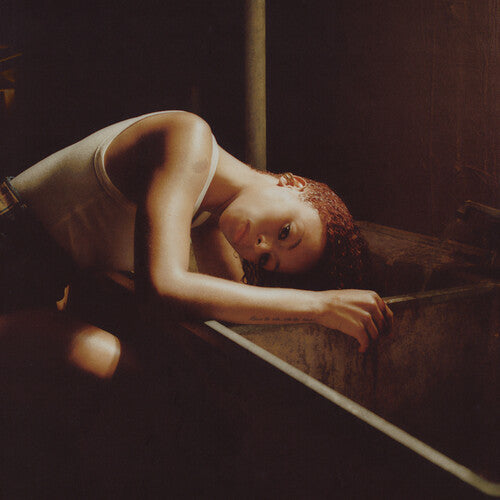 Person lying on a wooden floor with a dark background