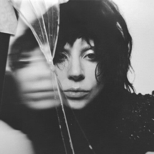Black and white photo of a person holding a broken glass bottle.