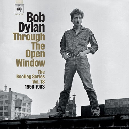 Album cover of 'Through The Open Window' by Bob Dylan with a black and white photo of a man on a rooftop.