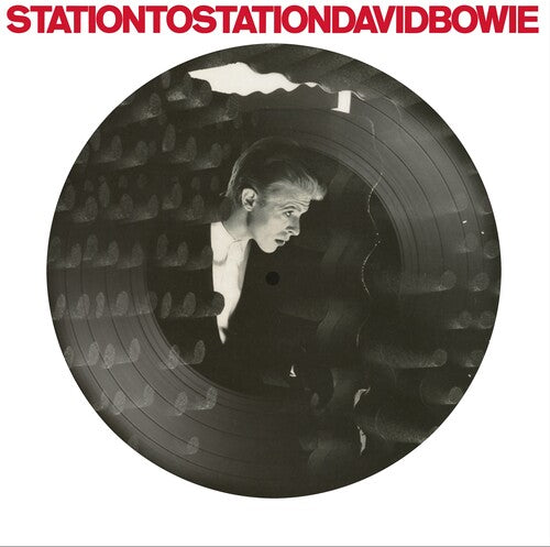 Vinyl record with a person's reflection and 'Station to Station David Bowie' text.