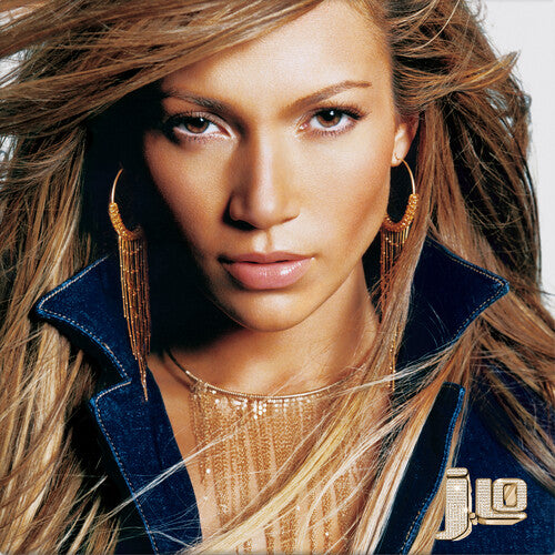 Close-up of a person with long hair wearing gold earrings and a blue jacket with a brand logo.
