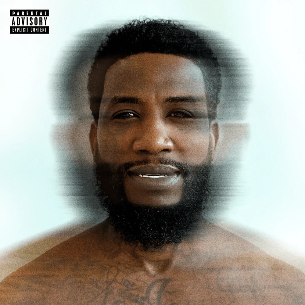 Man with a beard and tattoos on a white background with 'Parental Advisory' label.