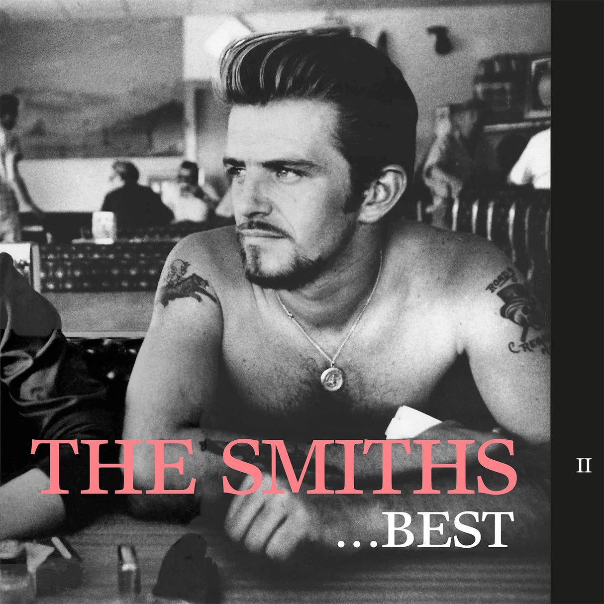 Album cover for 'The Smiths ...Best' featuring a shirtless man with tattoos in a room.