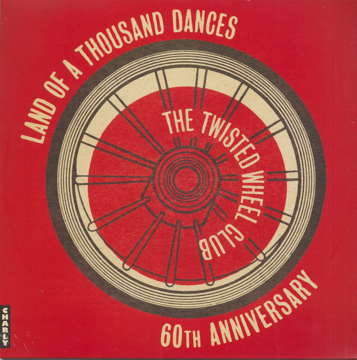 Album cover with a wheel design and text on a red background