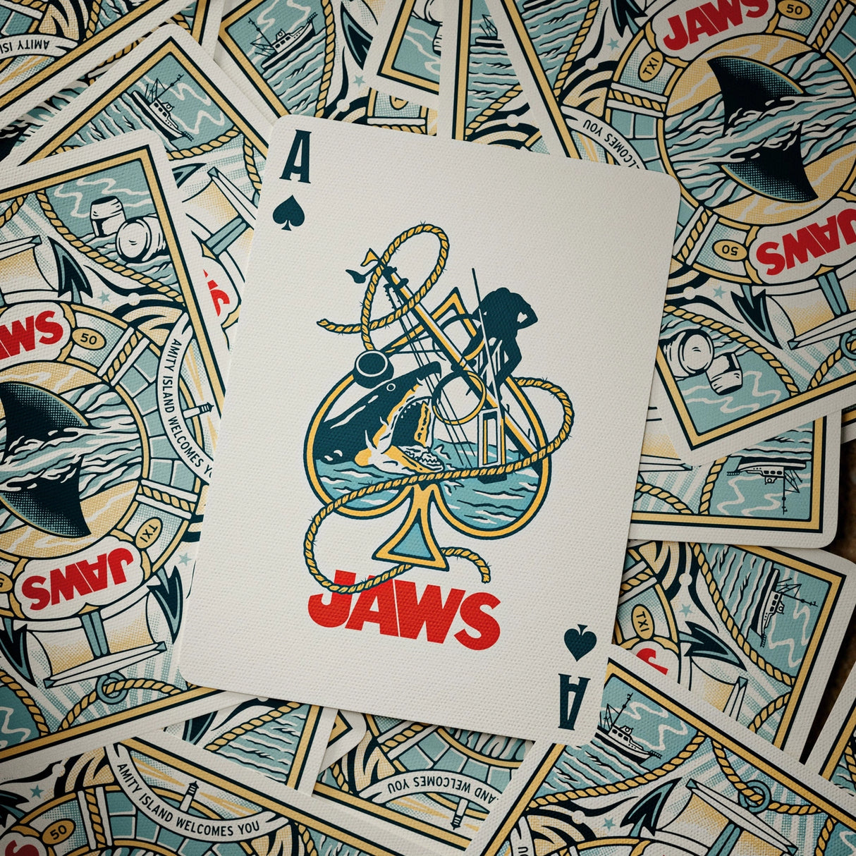 Playing card with 'Jaws' design on a background of more playing cards.