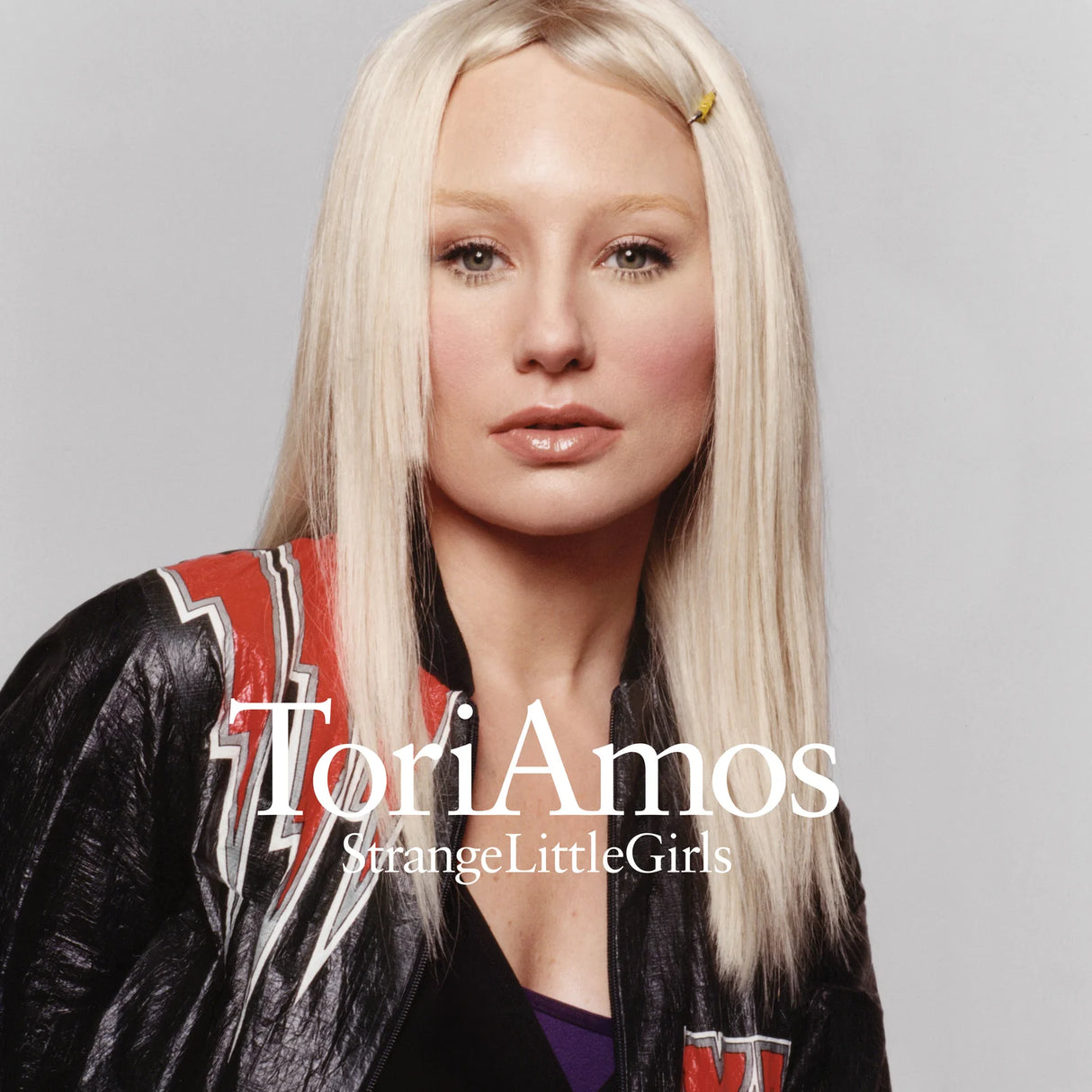 Album cover with a person wearing a jacket and the text 'Tori Amos StrangeLittleGirls' on a gray background