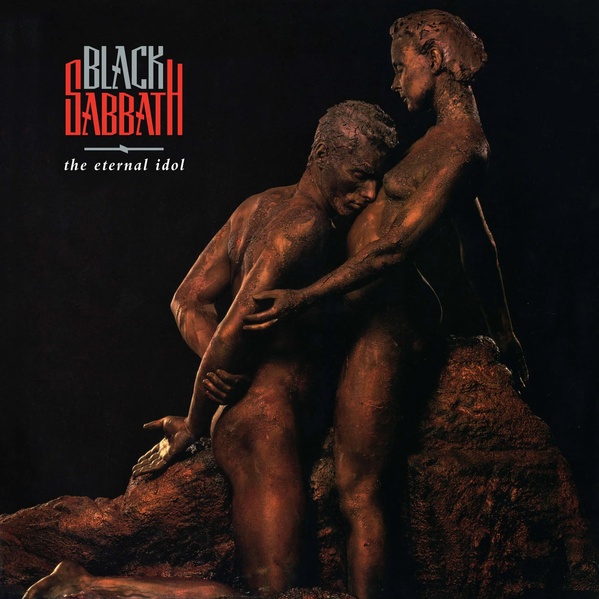 Album cover for 'The Eternal Idol' by Black Sabbath featuring bronze statue of two figures.