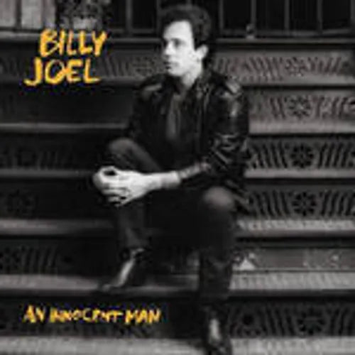 Album cover with a person sitting on steps, featuring the text 'Billy Joel An Innocent Man'.
