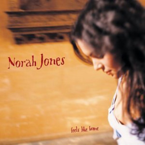 Album cover with 'Norah Jones' and 'Feels Like Home' text on a wooden surface.