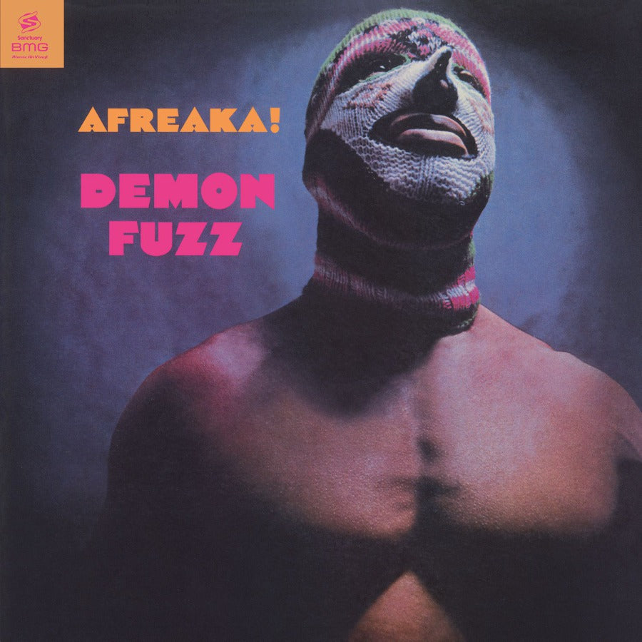 A record cover featuring a person with a mask-like face and the text 'Afreaka! Demon Fuzz' on a blue background.