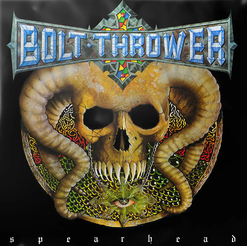 Album cover for Bolt Thrower's 'Spearhead' with a stylized skull and decorative elements.