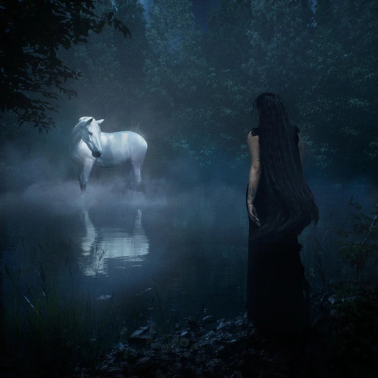 Woman standing in a misty forest with a white horse reflected in the water