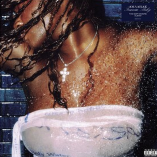 The image features the cover of the album 'Fountain Baby' by Amaarae. The cover artwork captures an intense, close-up portrait of the artist, who is seen from the shoulders up, with a cascade of wet, curly hair framing her face.