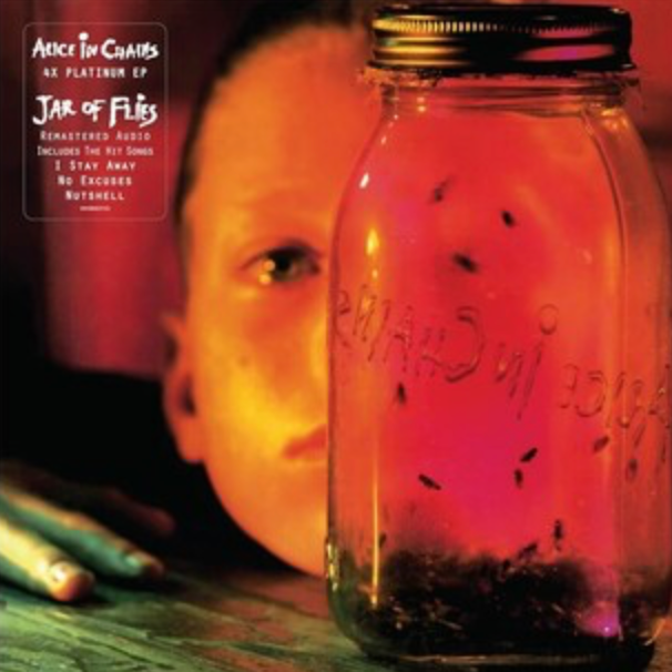 Album cover of Alice In Chains' Jar of Flies featuring a glass jar with insects inside, and a child's face illuminated in the background.