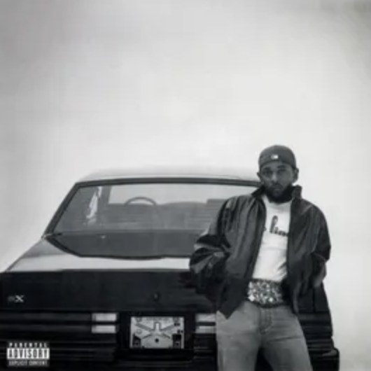 Black and white image of Kendrick Lamar standing in front of a car, with a sign indicating 'Parental Advisory'.