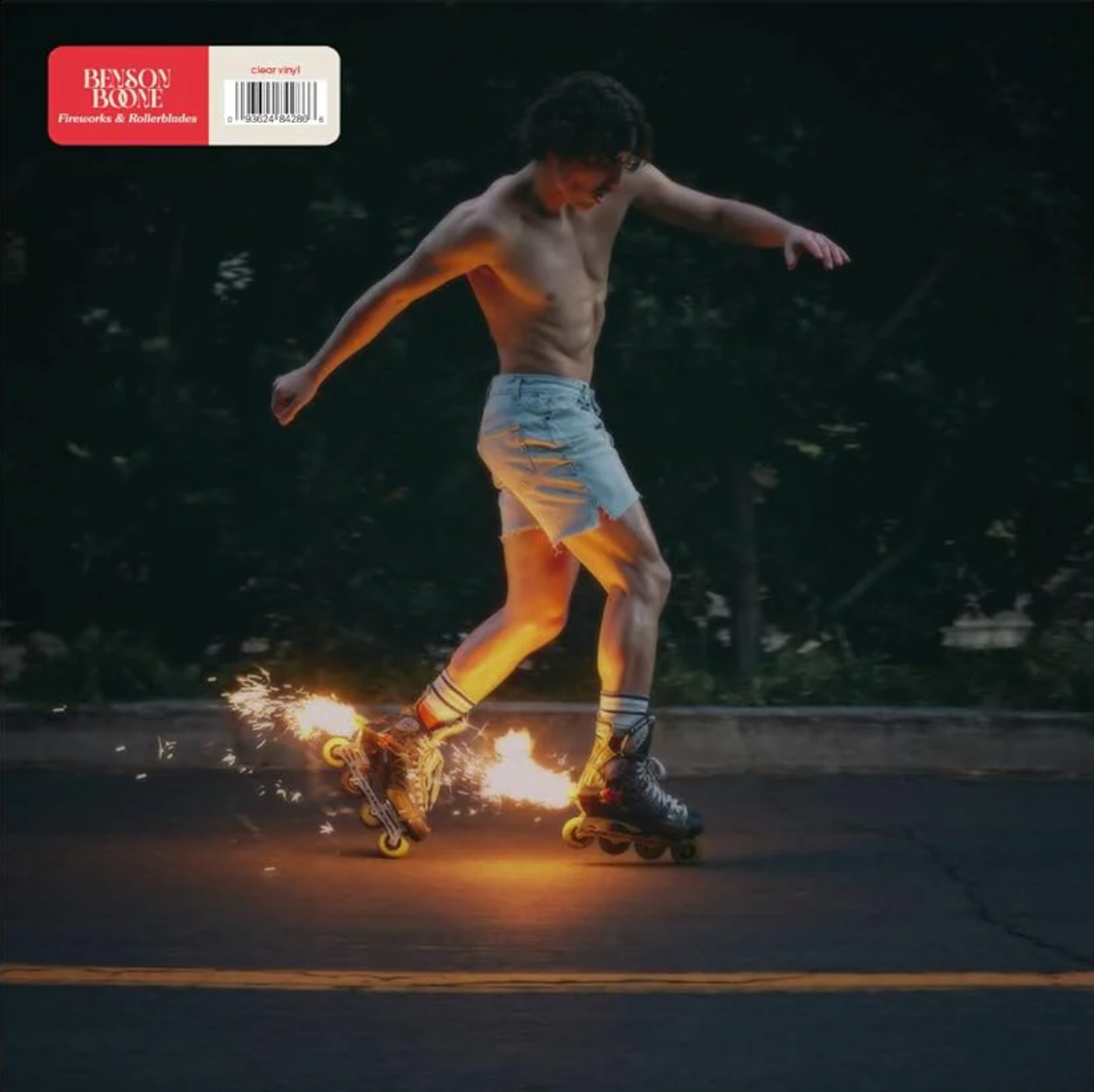 A person rollerblading at night with a sparkler, from the album 'Fireworks & Rollerblades' by Benson Boone.