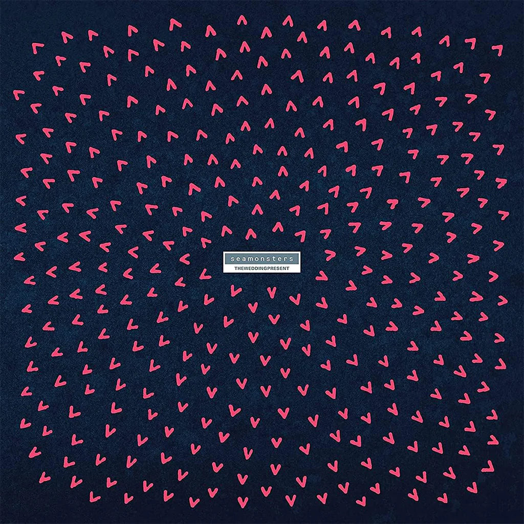 Navy blue background with pink heart pattern and a brand logo in the center.