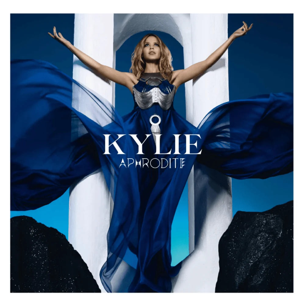 Album cover for 'Aphrodite' by Kylie featuring a woman in a blue dress with outstretched arms.