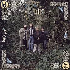 The album cover for 'The Union Jack' by the band The Who, featuring four band members standing in a dense, overgrown forest. The image has a decorative Celtic-style border with floral and knot motifs in the corners.