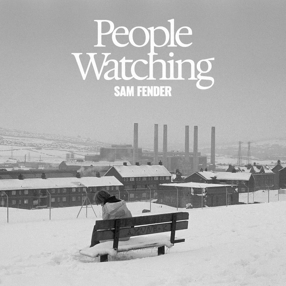 Album cover with 'People Watching' by Sam Fender, featuring a person on a bench in a snowy landscape.