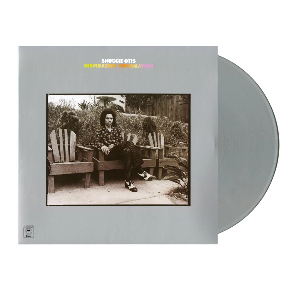 Vinyl record with cover featuring a person sitting on a bench in a garden, on a white background.