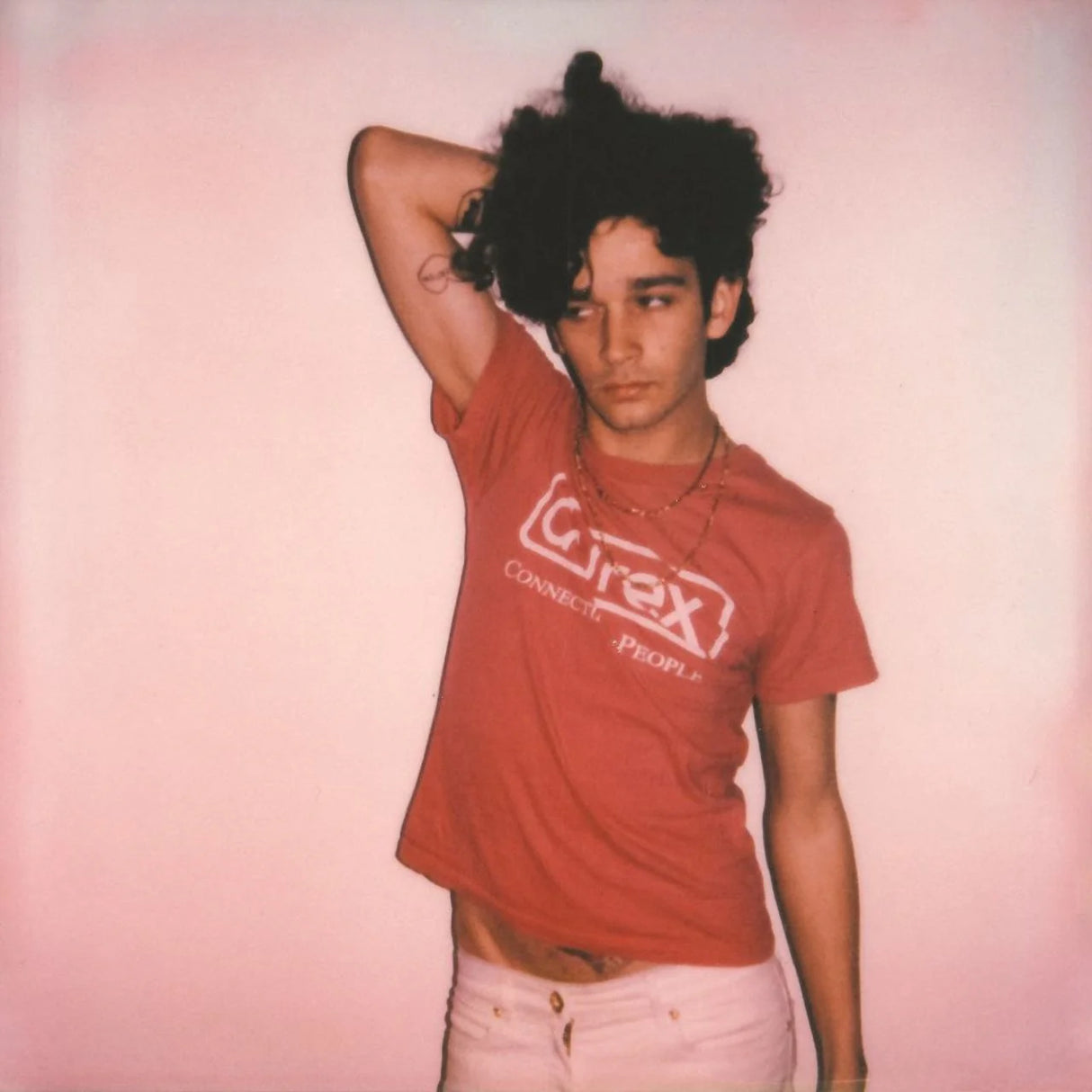 Person wearing a red 'Cirex' t-shirt against a pink background