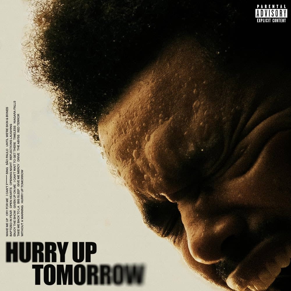 Album cover with a close-up of a person's face and 'Hurry Up Tomorrow' text.