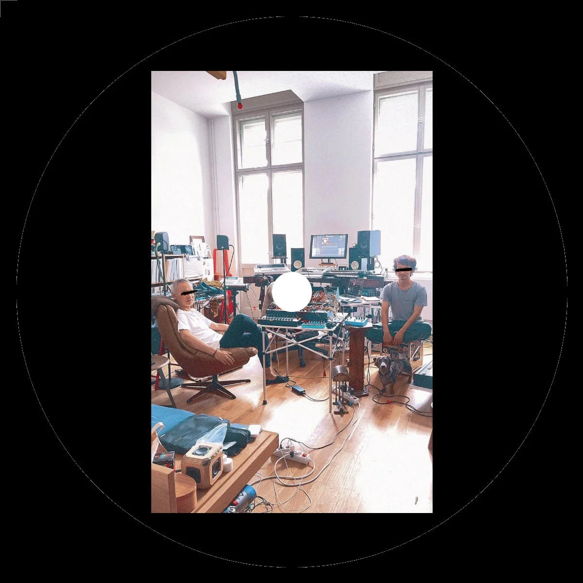 Two people in a room with various electronic equipment and monitors.