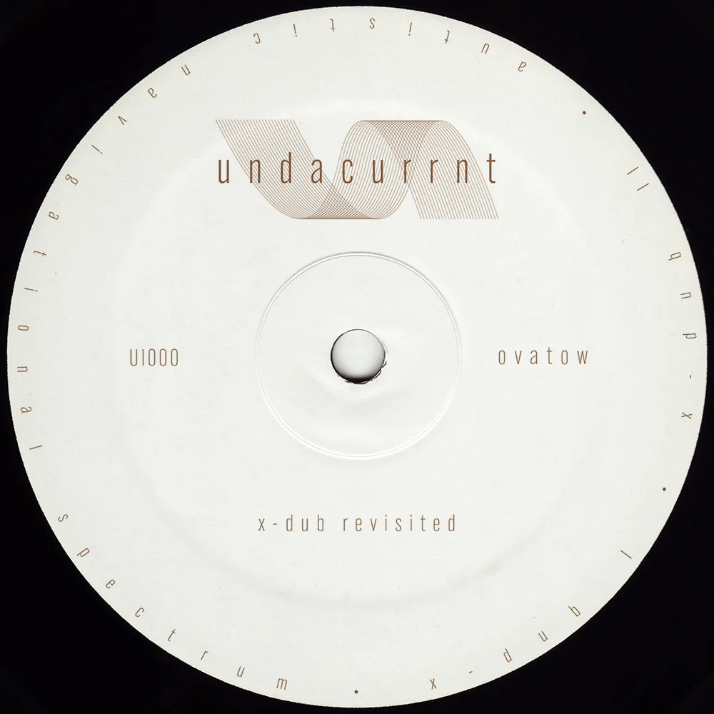 A circular vinyl record label with a white center and outer ring, featuring the text 'undacurrnt' and 'x-dub revisited' in a minimalist design against a black background.