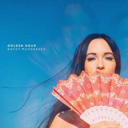 The cover art for Kacey Musgraves' album 'Golden Hour' features a woman holding a multicolored fan in front of her face with a blue sky in the background.