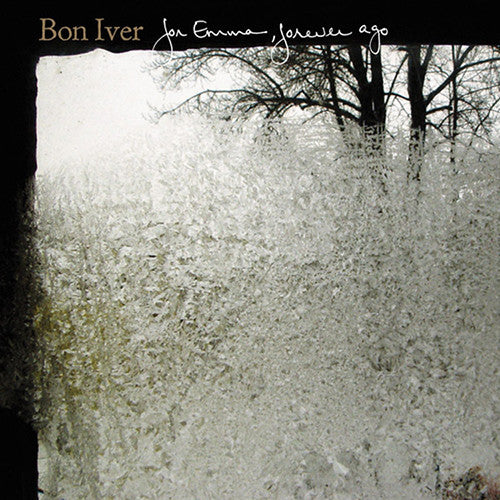 Album cover for Bon Iver's 'For Emma, Forever Ago' featuring a grayscale image of trees and snow-covered ground.