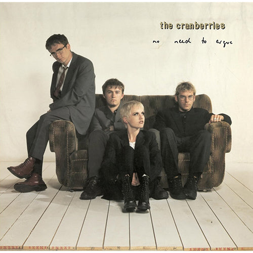 The Cranberries album cover for 'No Need To Argue' featuring members of the band sitting on a couch with their backs to the camera.