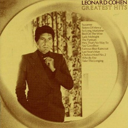 The image features the cover of the LP titled "Leonard Cohen - Greatest Hits." It shows a portrait of Leonard Cohen, framed in a circular mirror, looking contemplatively to the side.