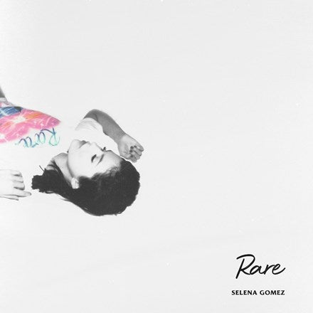 This image features the album cover for Selena Gomez's third studio album, "Rare." The cover art is minimalist, utilizing a black and white photograph of Selena Gomez in a playful, twisted pose with a colorful umbrella.