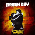 Cover art for Green Day's album 21st Century Breakdown featuring a black and white image of a couple kissing on a wall with a red and yellow painted background. The album title is at the top in bold white letters.
