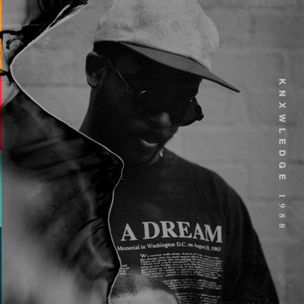 A black and white image of a person wearing a cap with the text 'A DREAM' printed on it, in front of which there is a projection of a hand holding a record with the label 'KNXWLEDGE 1988'.